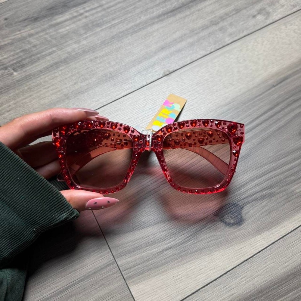Red glitter sunglasses with heart-shaped embellishments